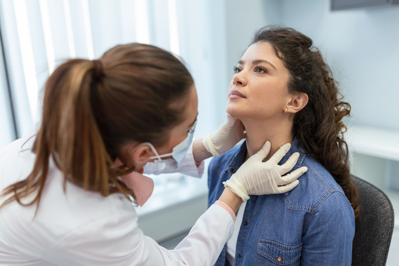 pharmacist checking thyroid on patient