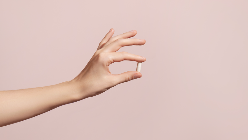 woman holding supplement