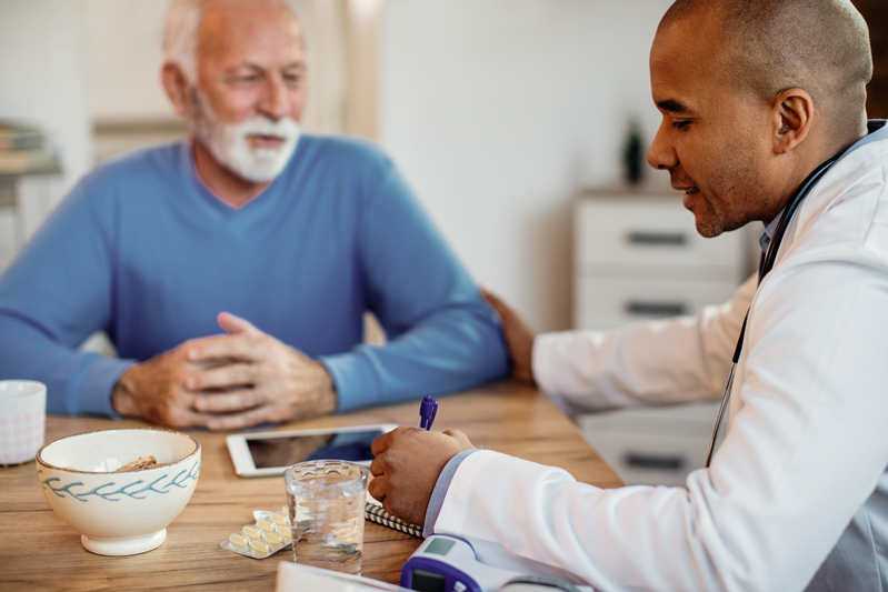 elderly man meeting with doctor