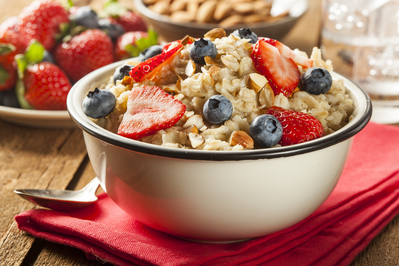 bowl of oatmeal topped with berries and almonds