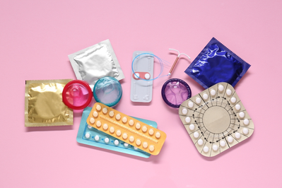 assortment of birth control methods, including pills, IUD, condoms, implant