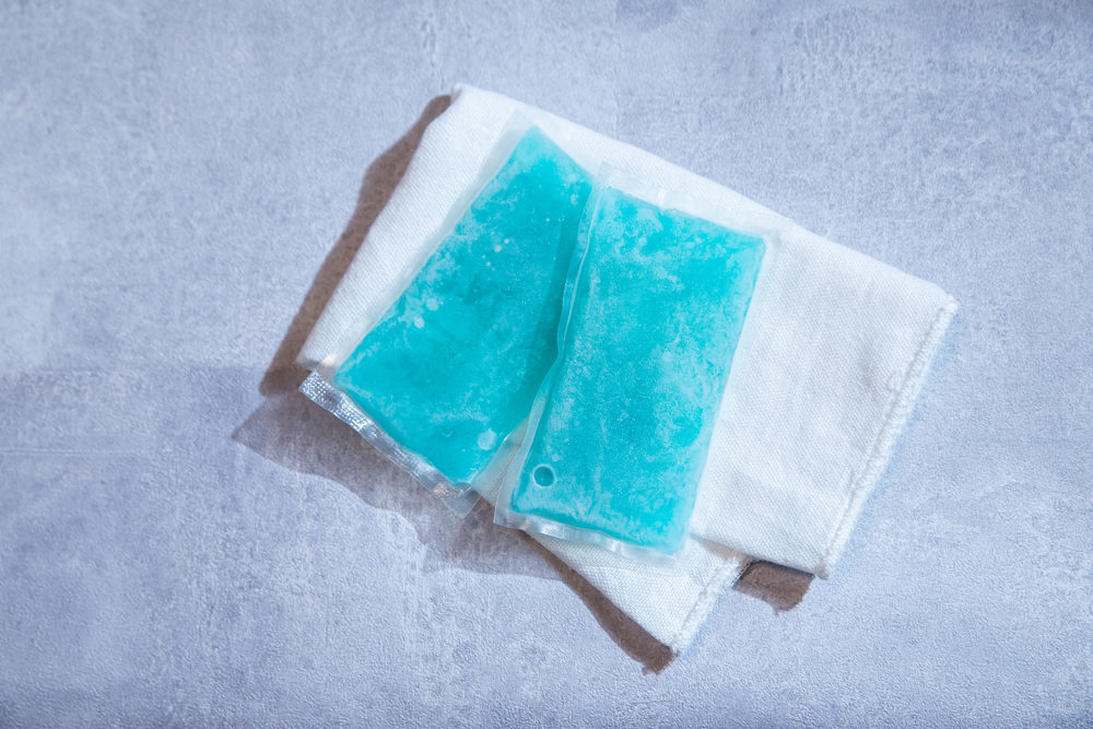 two frozen ice packs on white towel