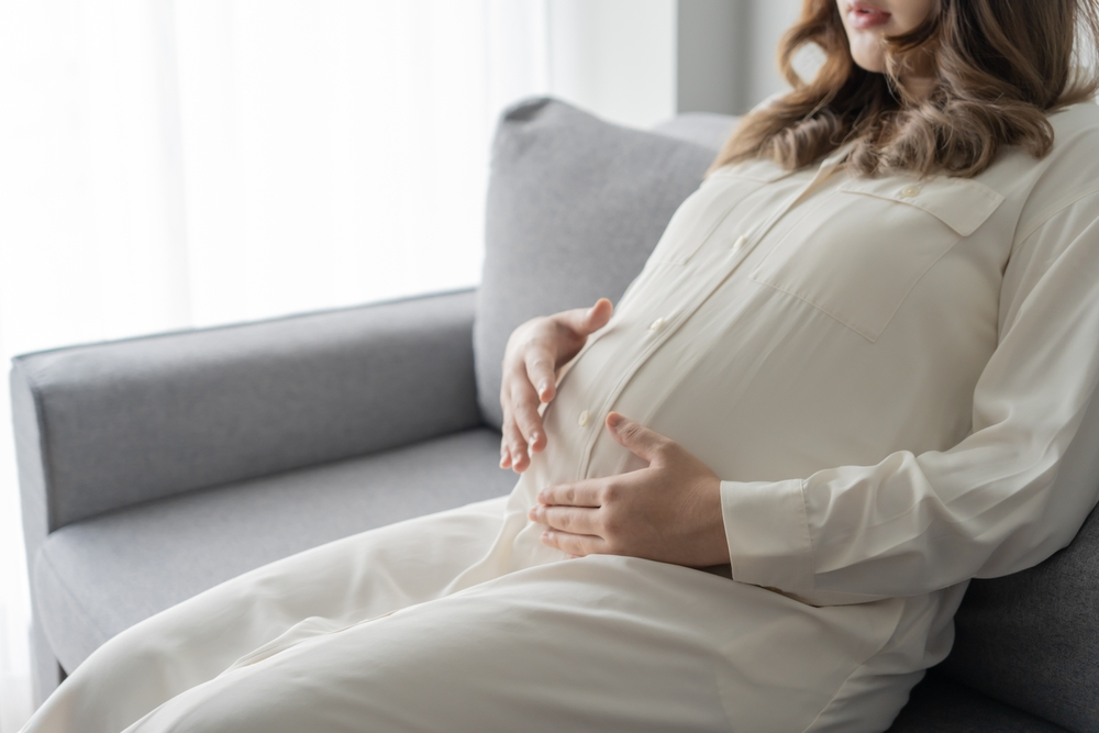 woman holding pregnant belly